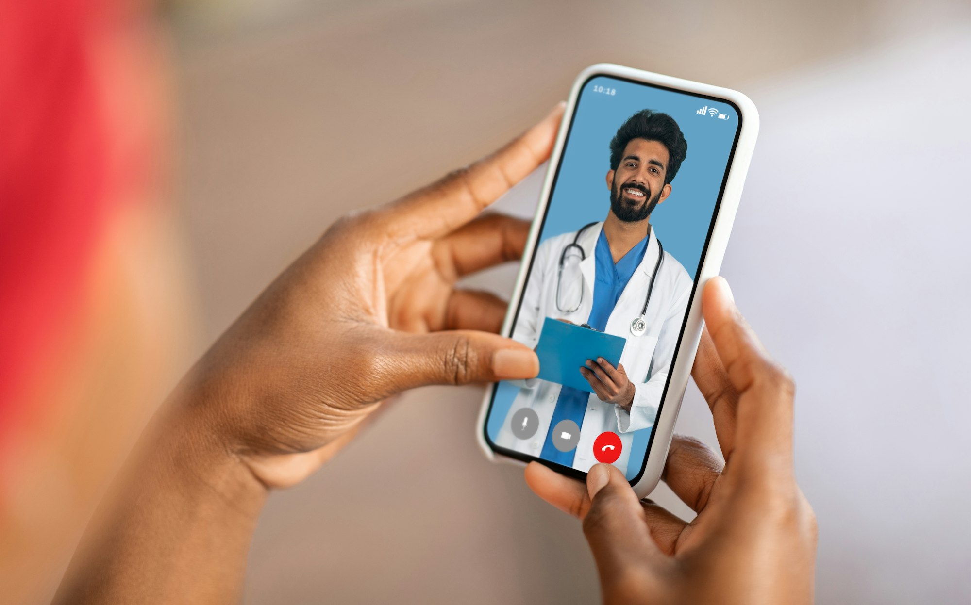 Indian Doctor Consulting Female Patient Online Via Video Call On Phone